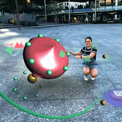 Person interacting with Artificial Ecology AR art outside