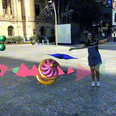 Person interacting with Artificial Ecology AR art outside