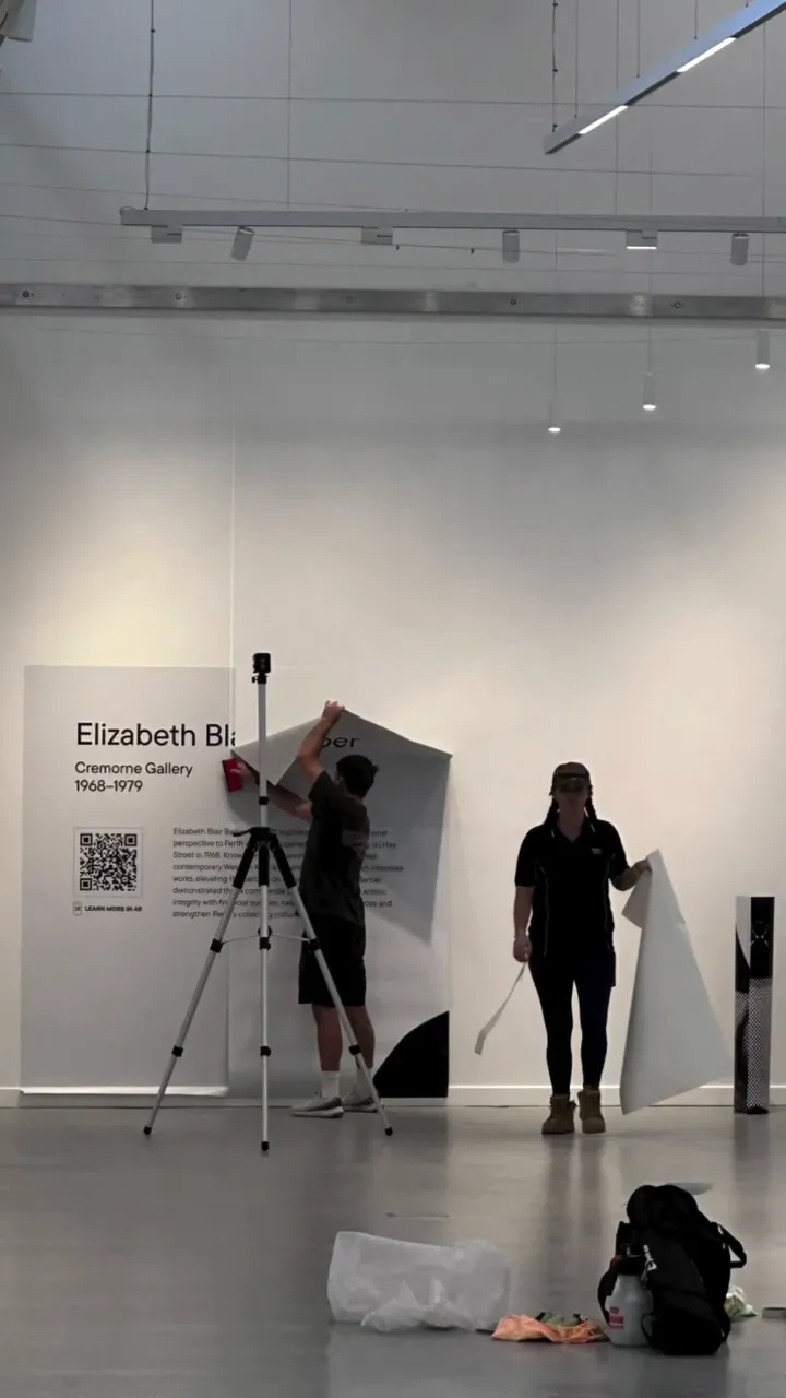 Install view of the Pioneering Spaces exhibition at Gallery Central, showing the Elizabeth Blair Barber panel being mounted
